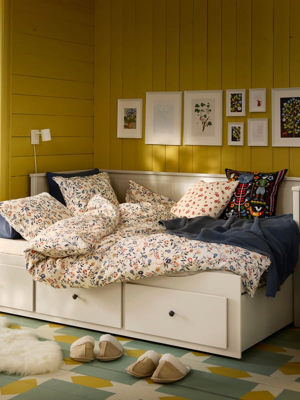 A multicolour TRATTKAKTUS cushion cover in the bedroom.
