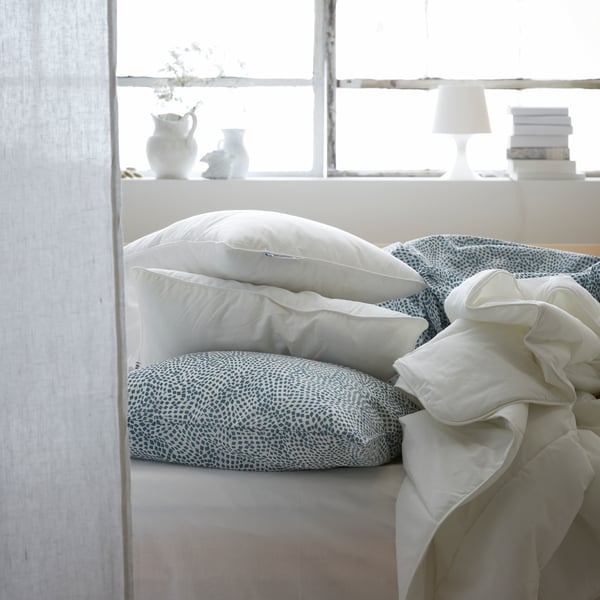 A white LAMPAN table lamp in the bedroom