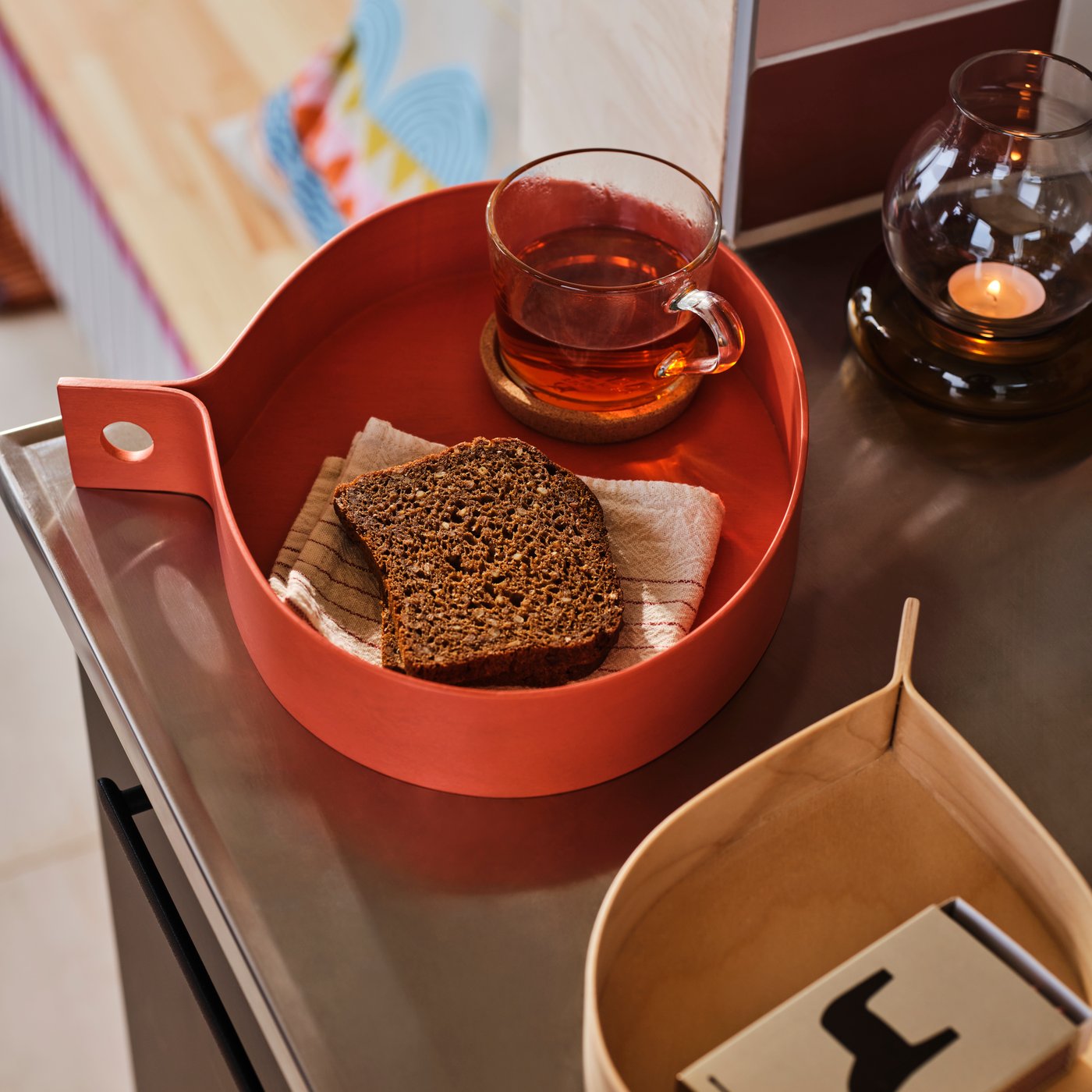 An orange/birch veneer OMMJÄNGE tray