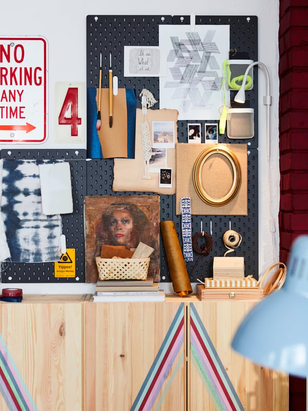Five SKÅDIS pegboards placed on a wall. These are filled with photos, frames and materials to create an inspiring mood board.