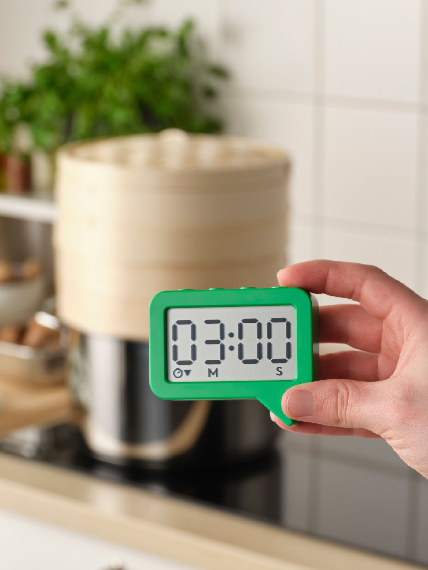 A green LJUNGPIPARE clock/timer in the kitchen