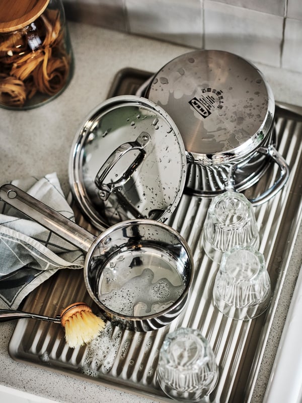 A beige/galvanised VÄLVÅRDAD dish drainer