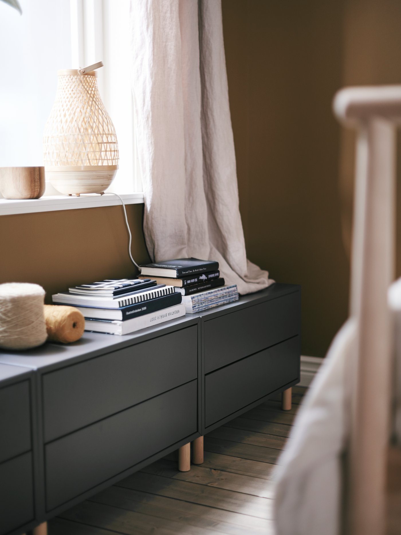 Three EKET cabinets turn the space below a low window into smart extra storage.