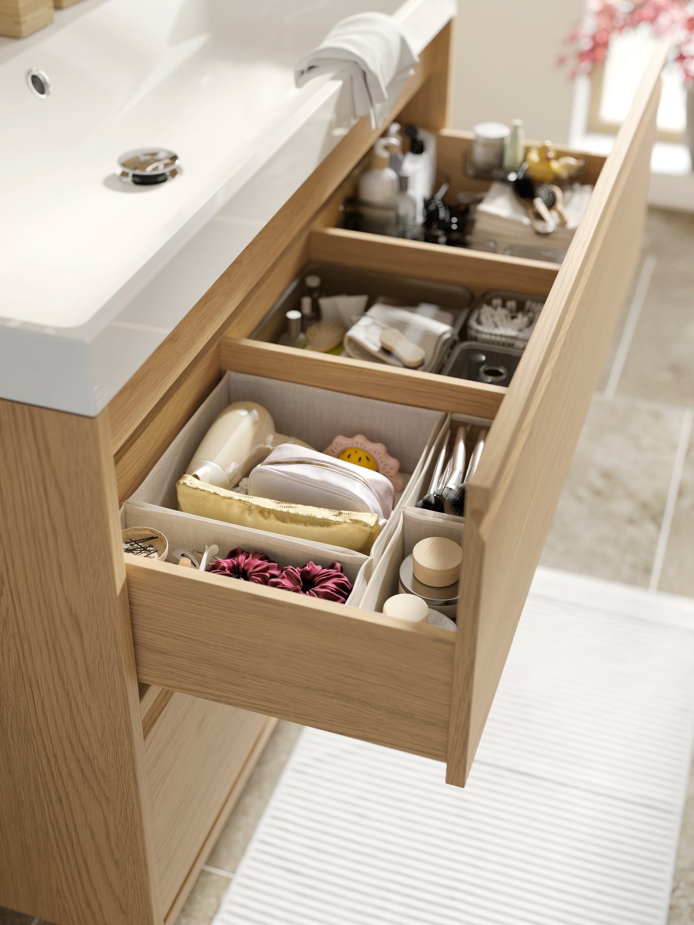 Open bathroom vanity drawer with VISSLAÅN organizers inside