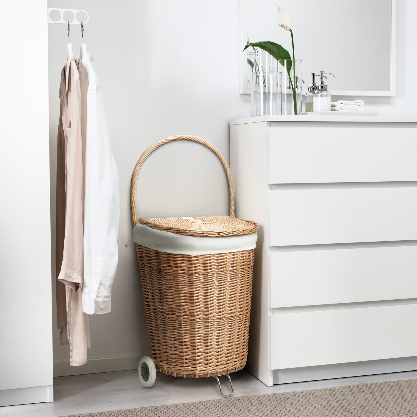 A handmade Willow TOLKNING laundry basket with wheels