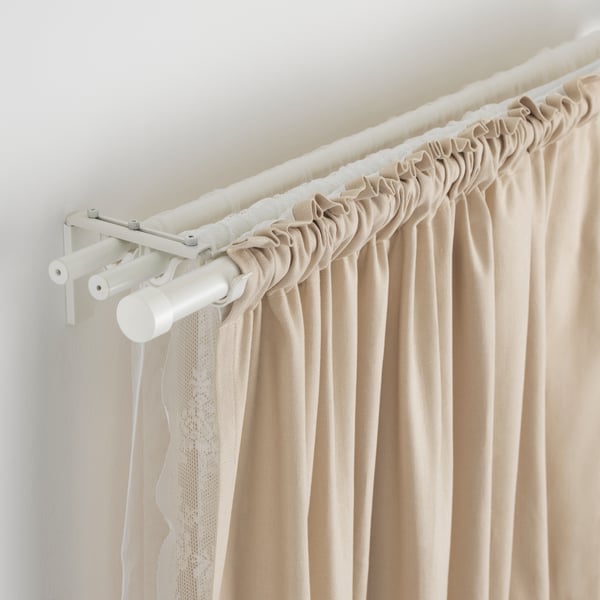 Three layers of HUGAD curtain rods mounted on the wall