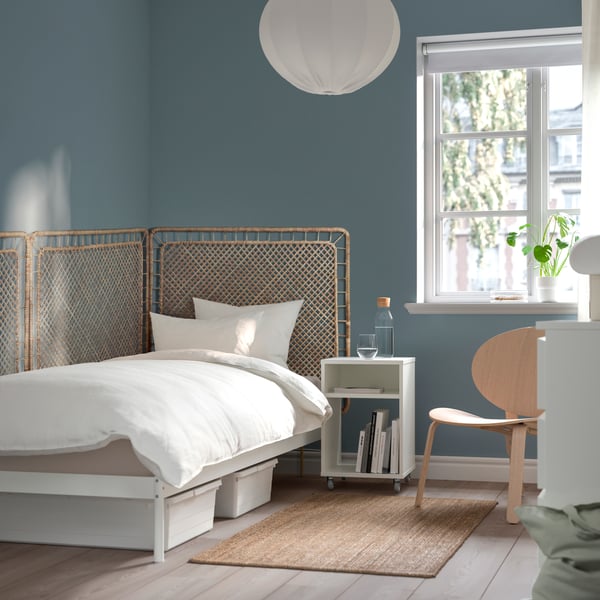 A white/Tolkning rattan VEVELSTAD bed frame with 1 headboard in the bedroom