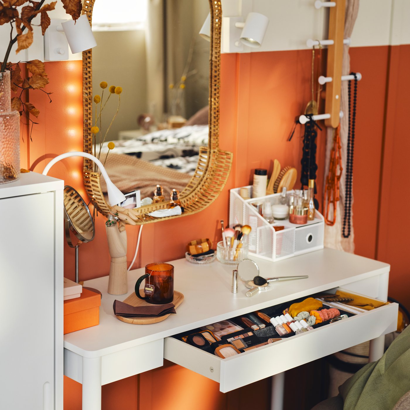 Makeup station with a mirror and various makeup products neatly arranged on the table in front.