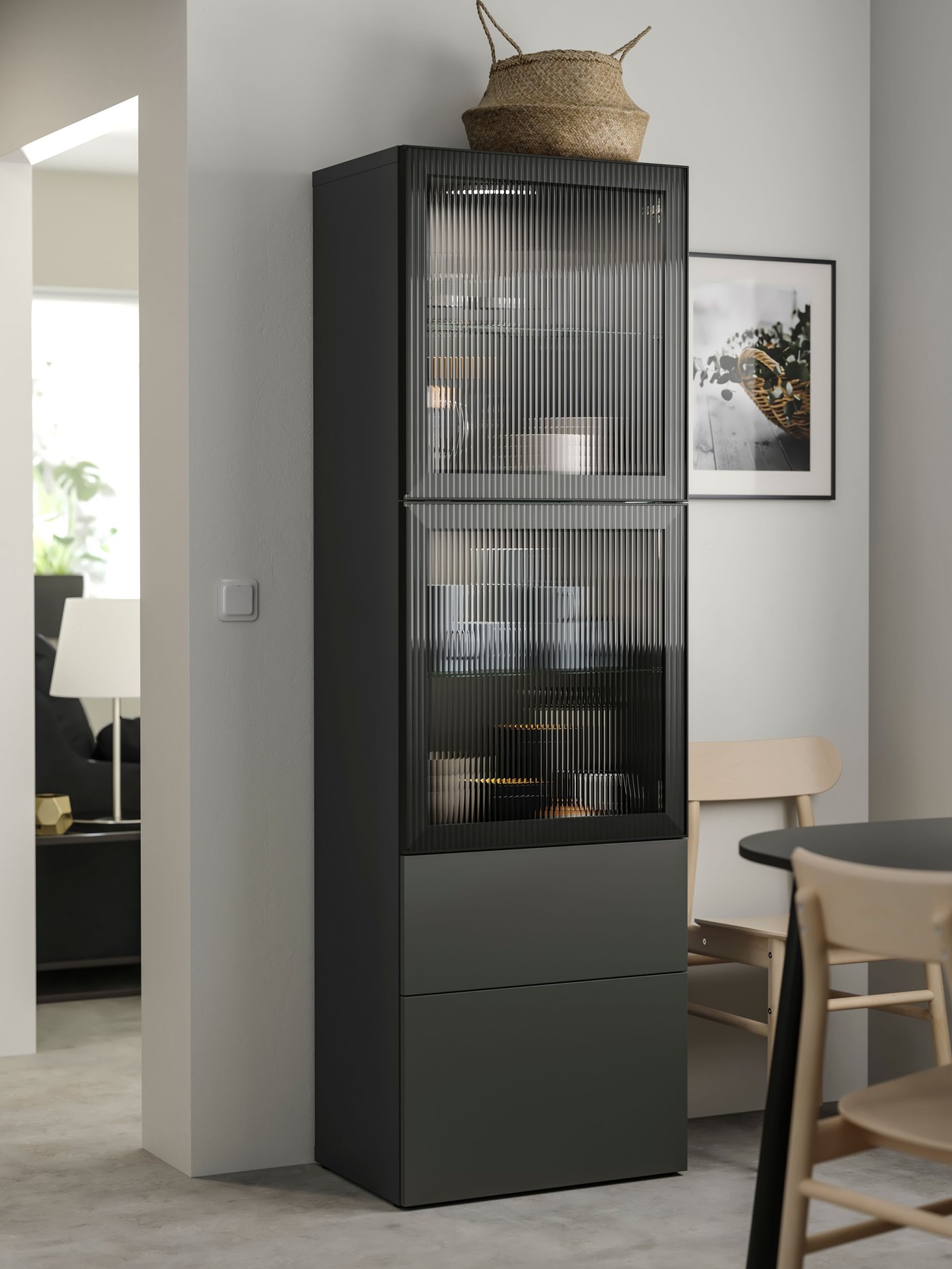 BESTÅ storage sideboard cabinet with grey fronts and FALLSVIK doors in the dining room with an assortment of items stored inside. 
