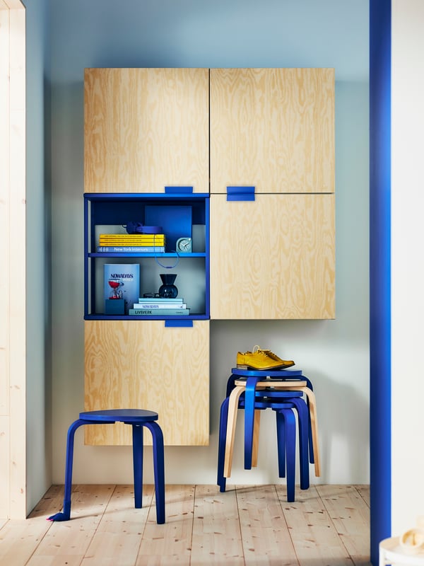 Large PLATSA wardrobe with one door open, showcasing clothes and bags on a clothes rail, on shelves, and in wire baskets.