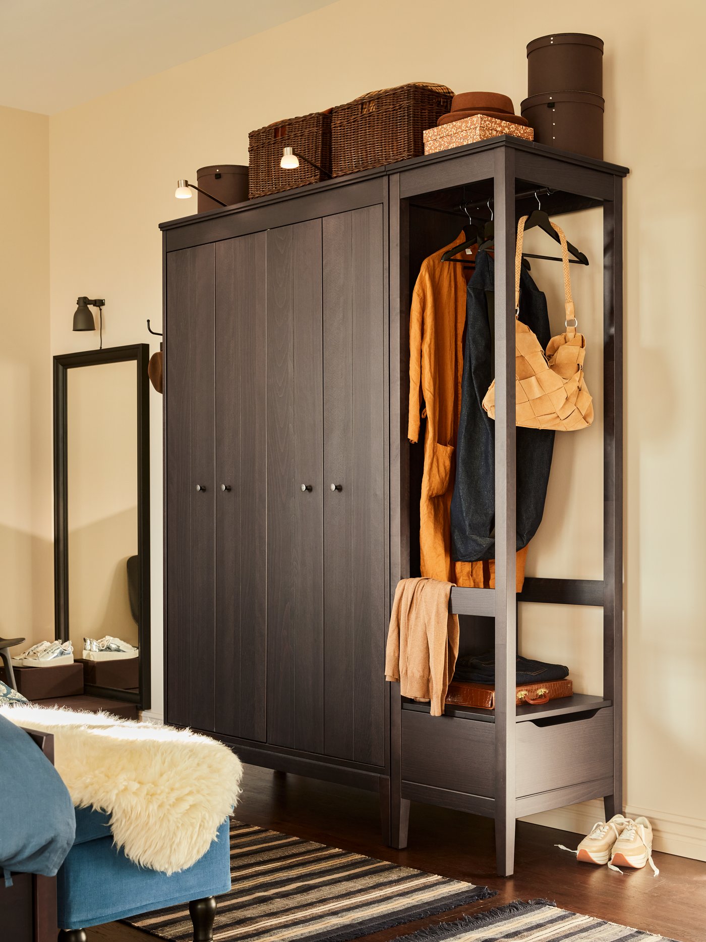 Dark wood IDANÄS wardrobe in bedroom.