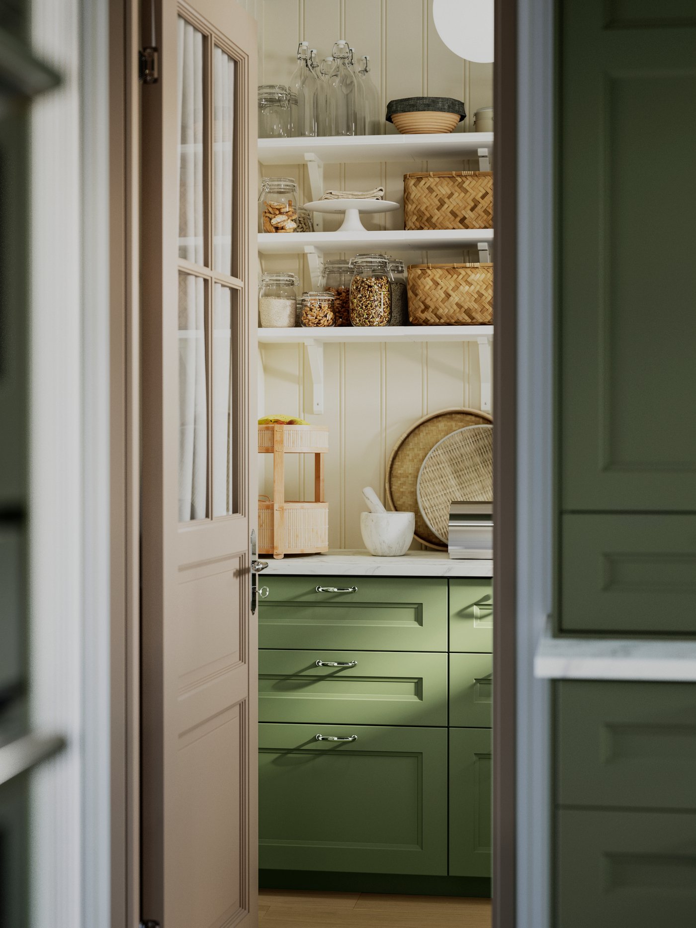 A pantry with AXSTAD grey-green kitchen fronts, open shelves displaying jars and baskets, and kitchen items. 