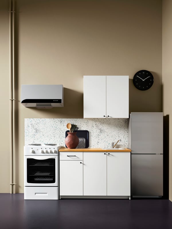 A white KNOXHULT wall cabinet with doors in the kitchen