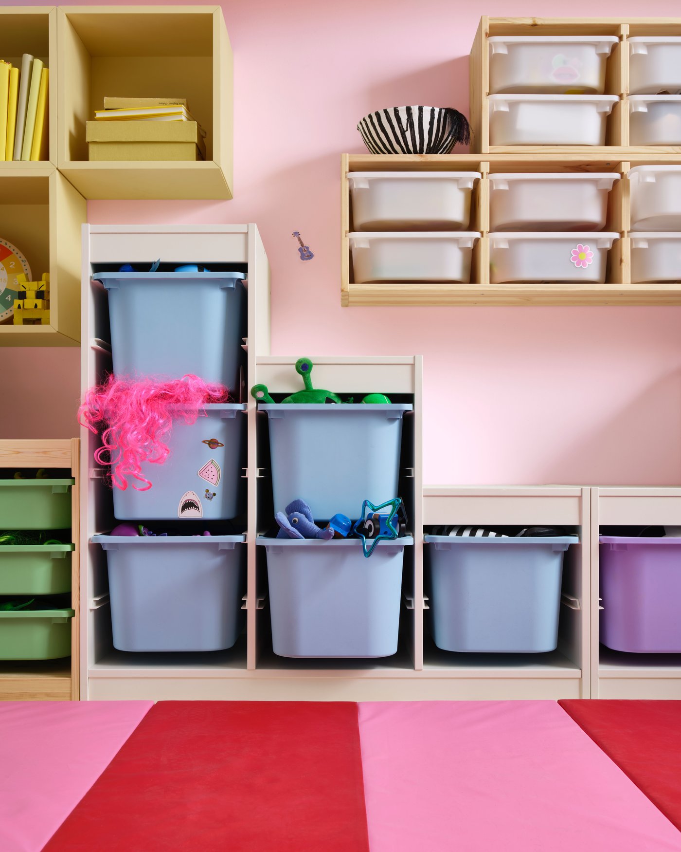 A light white stained pine/white TROFAST wall storage in the childrens room