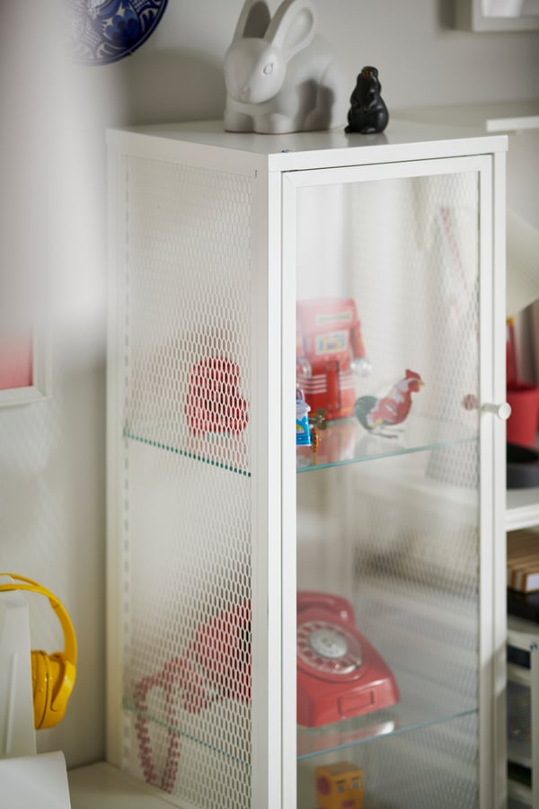 A metal/white BAGGEBO glass-door cabinet in the living room