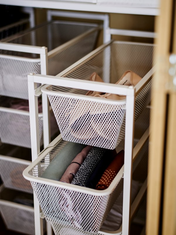 A white JONAXEL storage combination in the bedroom