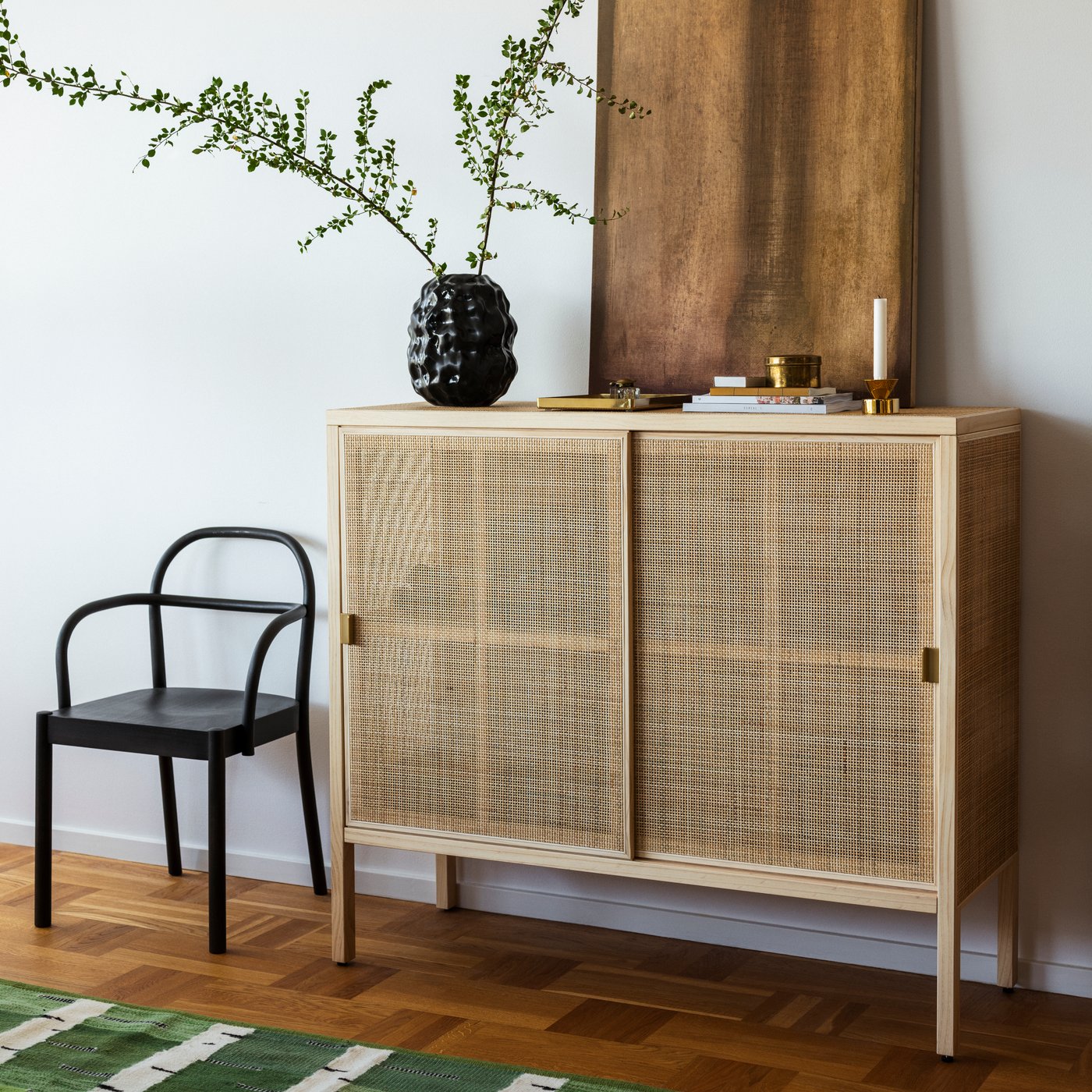 A STOCKHOLM 2025 sideboard with woven sliding doors and a light wood finish.