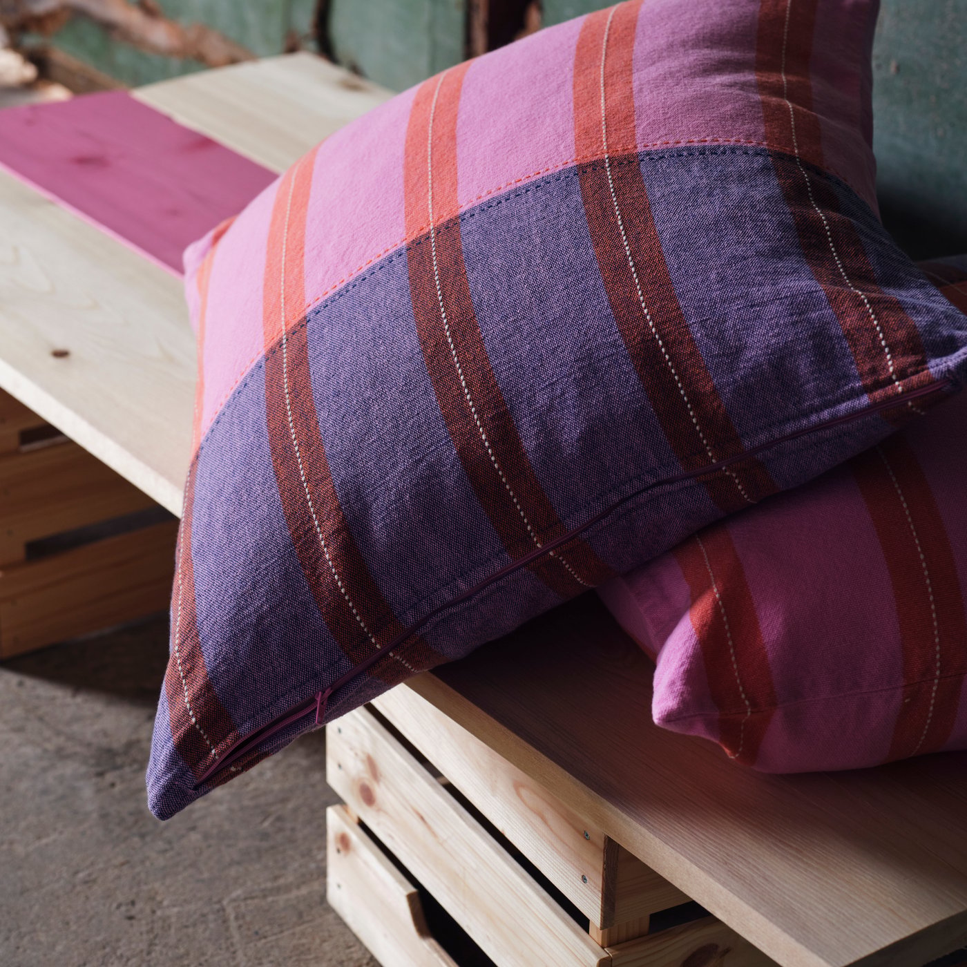 A pink/orange MÄVINN cushion cover