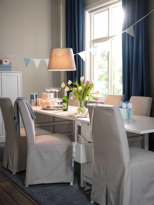 Dining table with a soft silky blue curtain