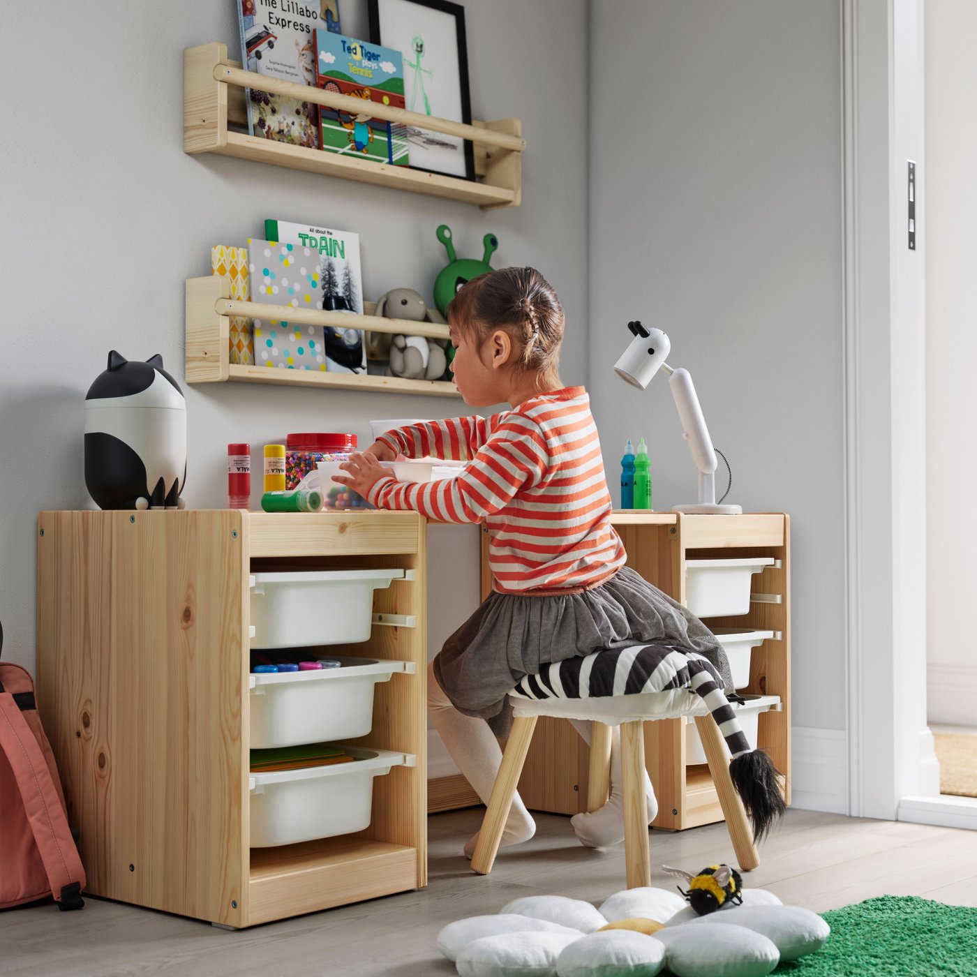 A light white stained pine white TROFAST desk with storage boxes in the childrens room
