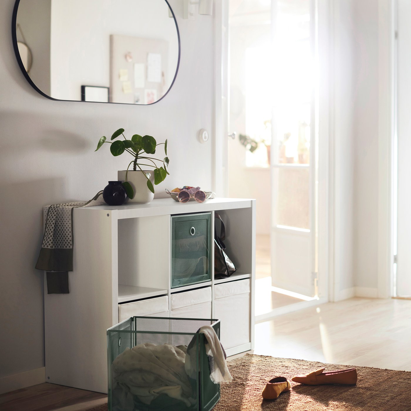 A white KALLAX shelving unit in the hallway