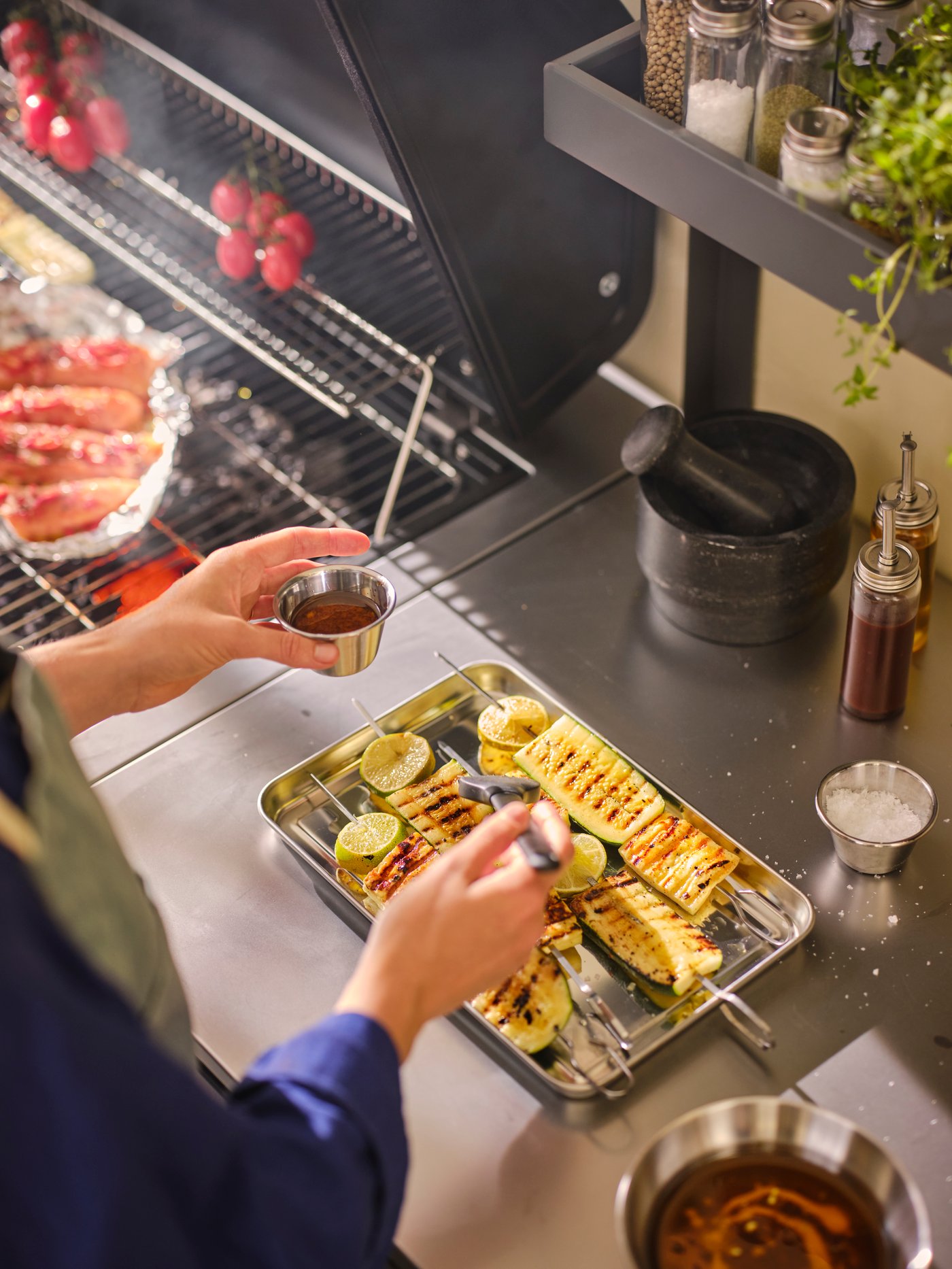 A stainless steel GRILLTIDER serving tray