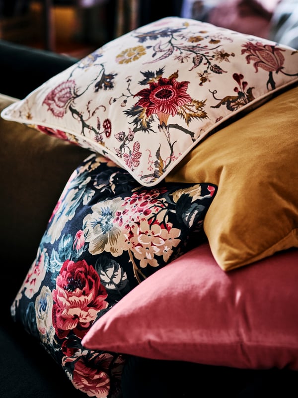 Two cushions with floral patterned NÄSSELKLOCKA and LEIKNY cushion covers and two with SANELA cushion covers.