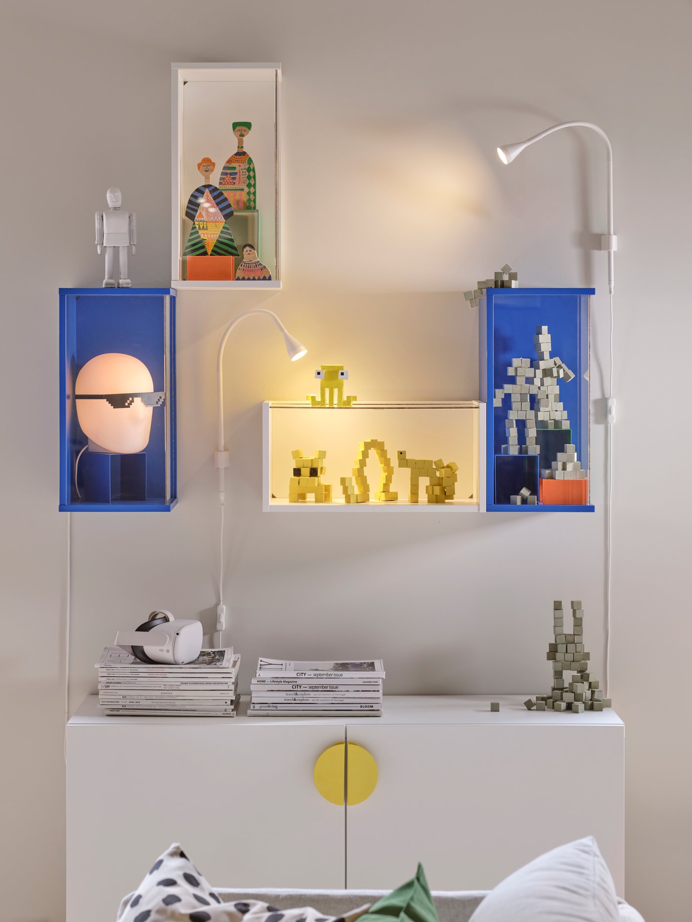 A bright blue BRÄNNBOLL wall-mounted display cabinet