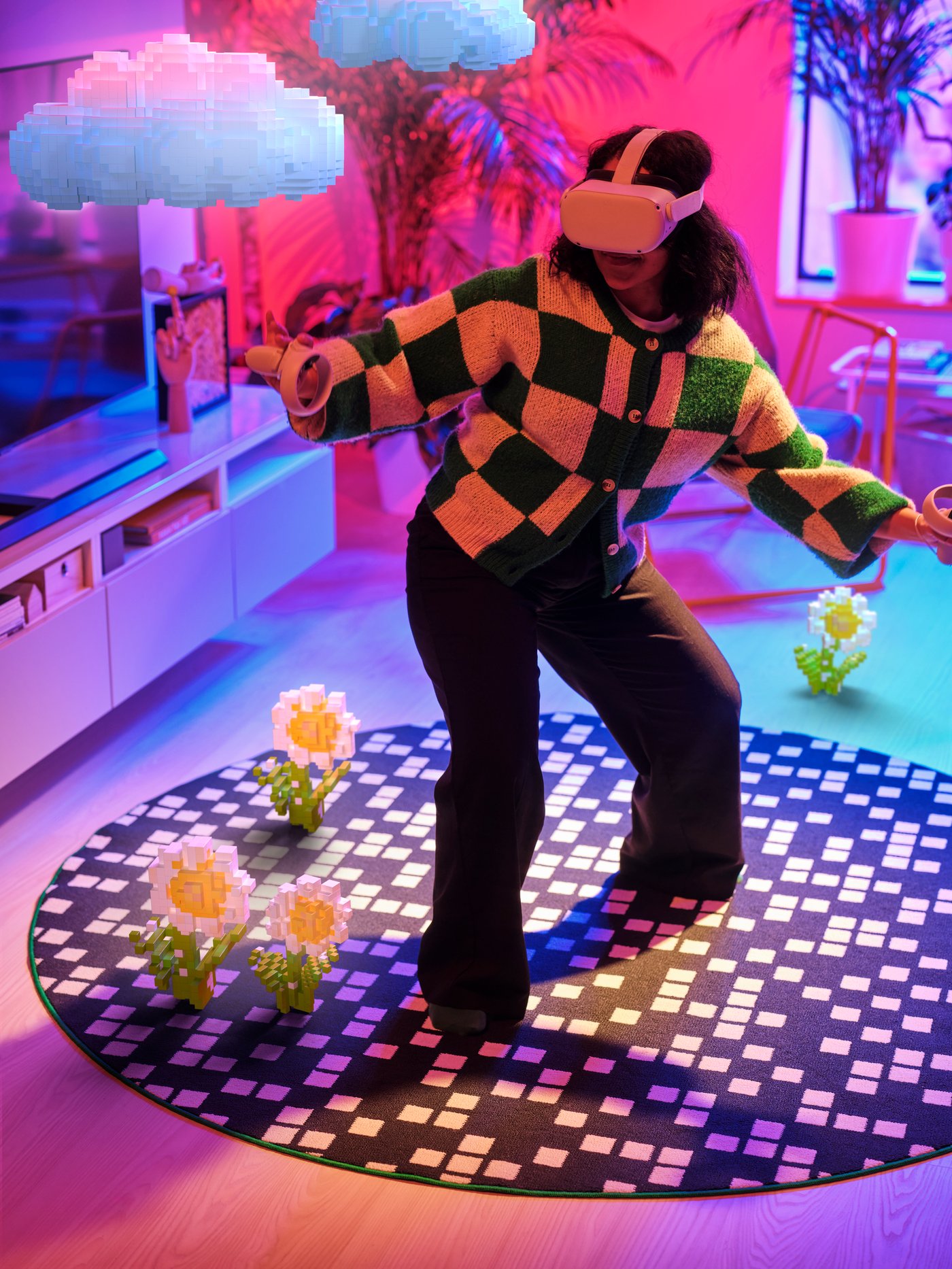 A person wears an AR headset and plays a game while standing on a BRÄNNBOLL gaming rug in black in a room.