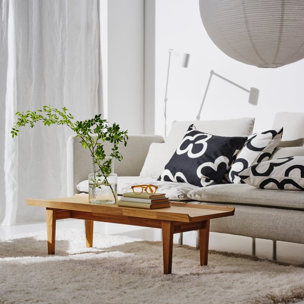 A white/black KLIPPBRÄCKA cushion cover in the living room