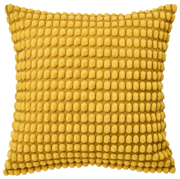 A cushion covered in a yellow SVARTPOPPEL cushion cover.