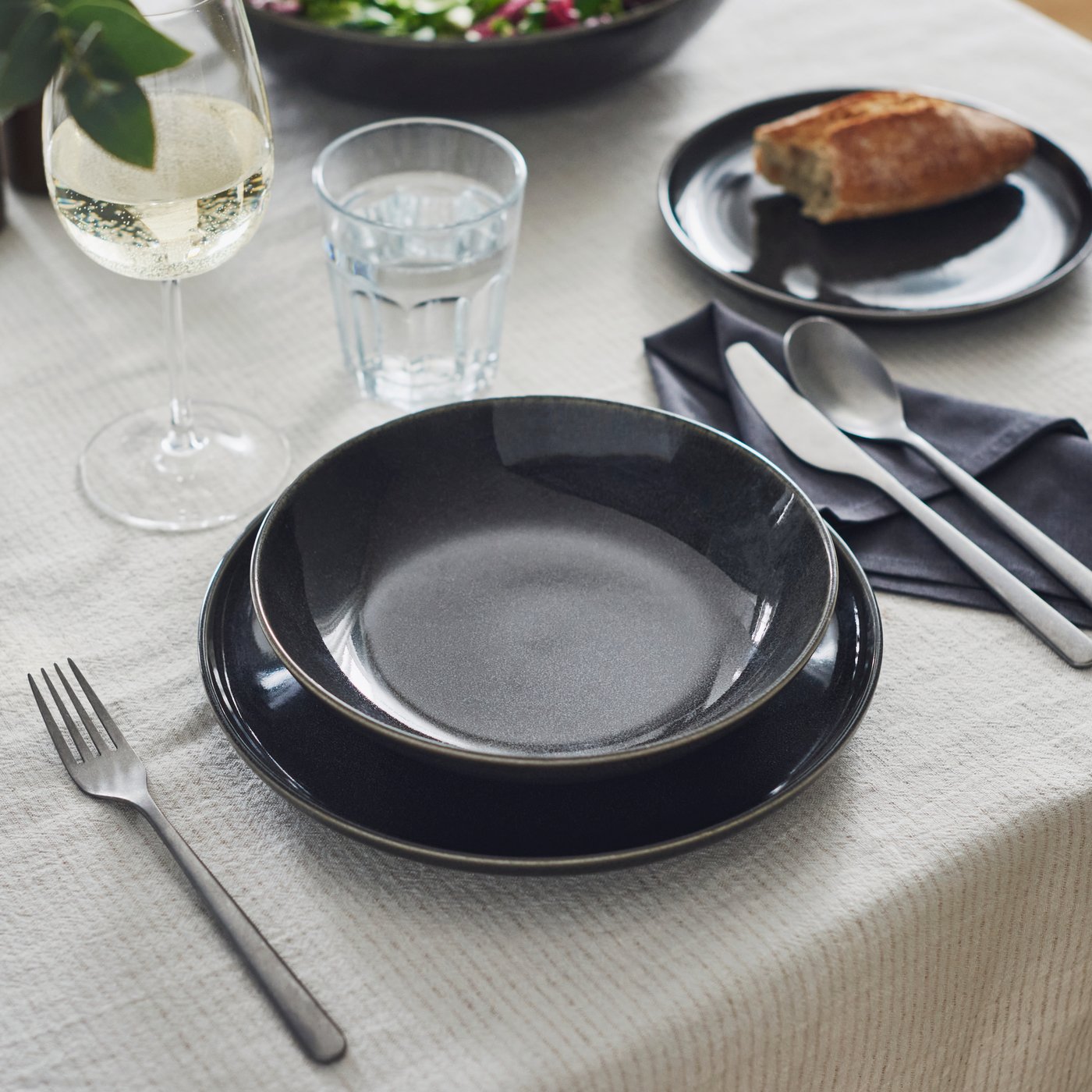 A dark grey GLADELIG side plate