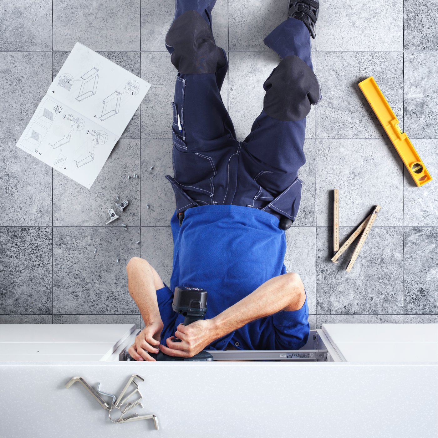 A person installing a kitchen