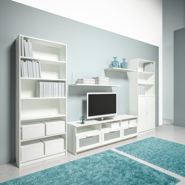 A TV stand with a flat screen TV against a white wall.