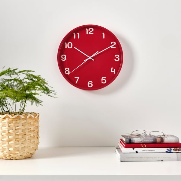 A red PLUTTIS wall clock