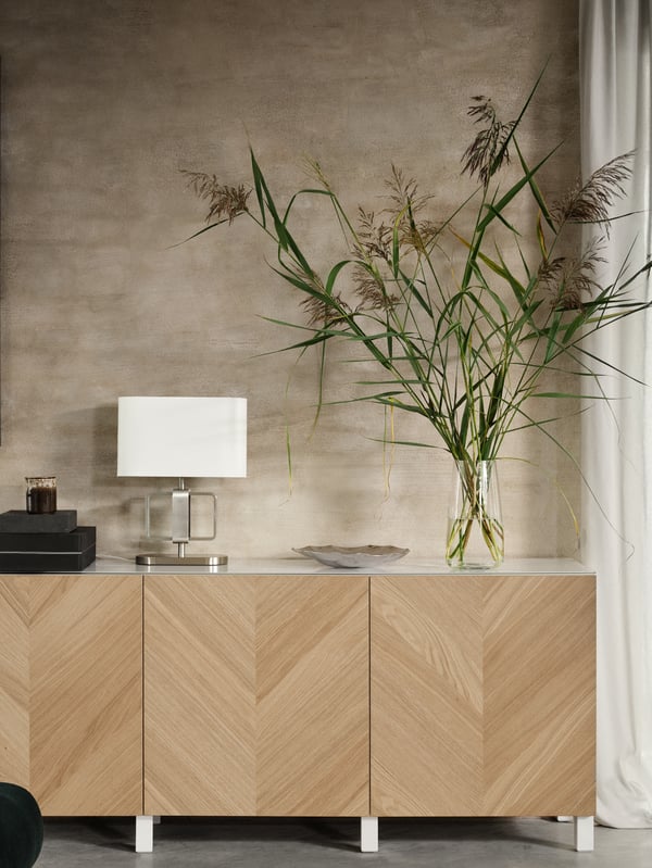 A BESTÅ TV unit with HEDEVIKEN doors featuring a herringbone pattern.