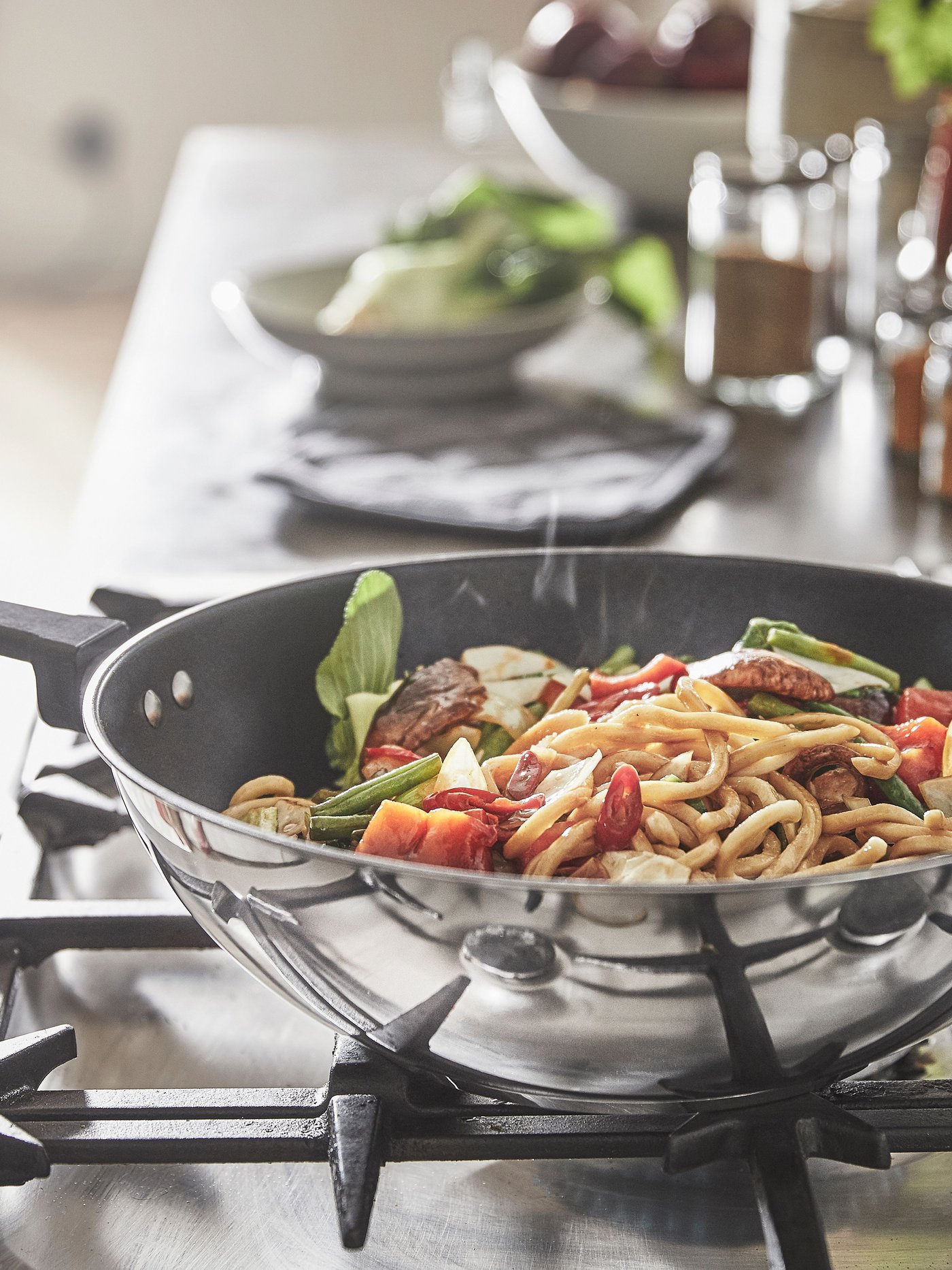 A non-stick coating/stainless steel MIDDAGSMAT wok in the kitchen