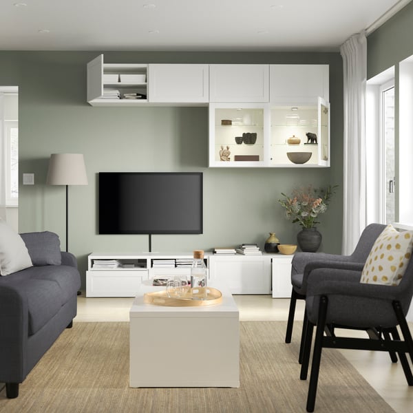 BESTÅ tv storage solution system in living room setting with integrated lighting against a pink and cosy wall 