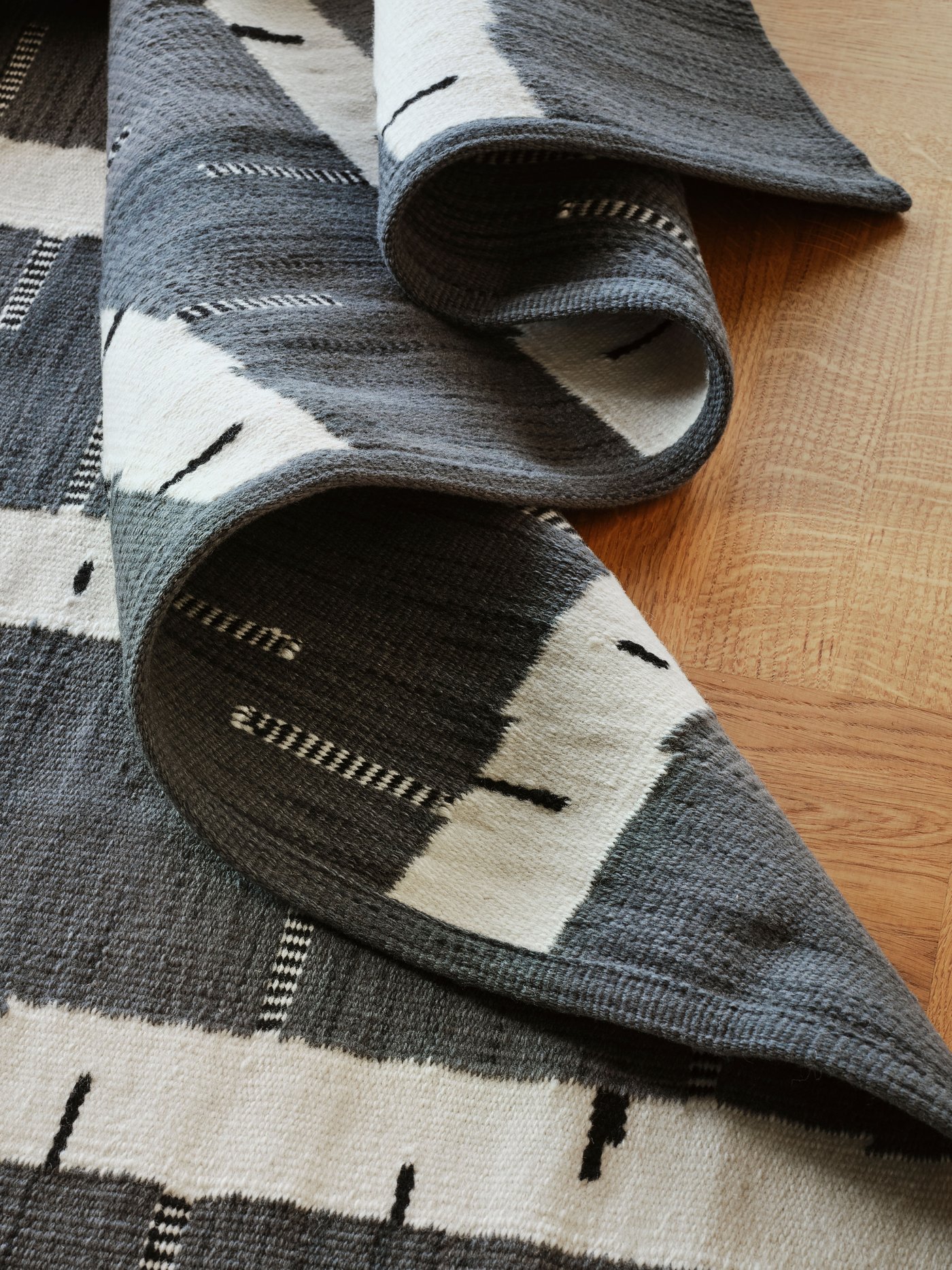 A grey/white/black handwoven STOCKHOLM 2025 rug, flatwoven