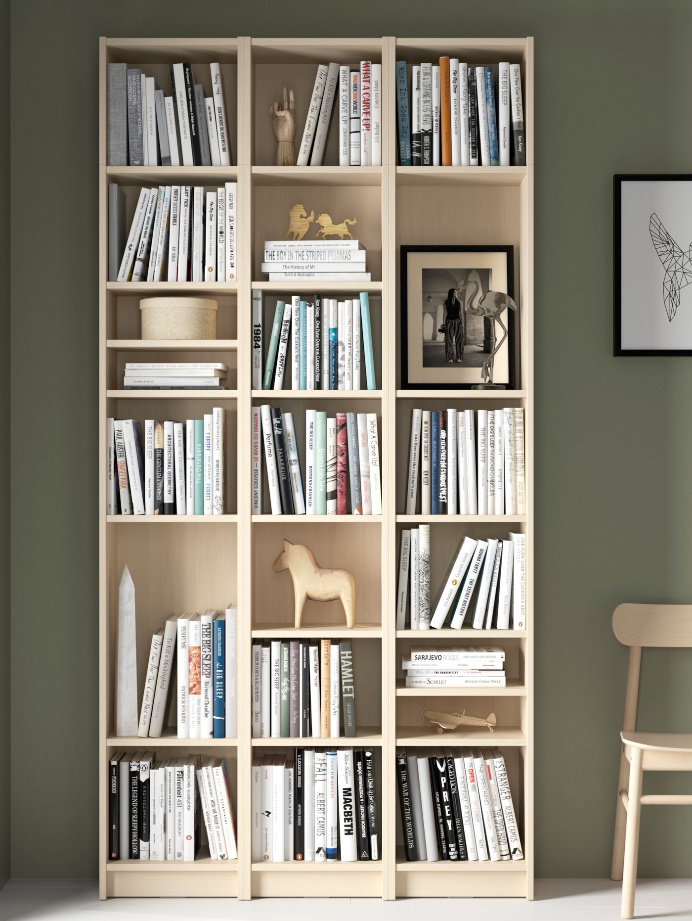 A BILLY bookcase combination with extension units in birch effect with plenty of books and decorative items on the shelves.