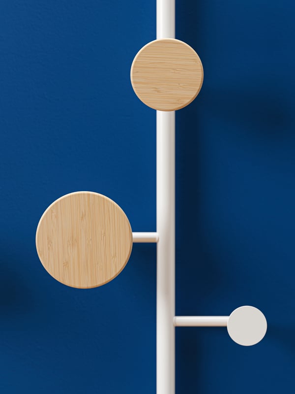 Against a dark blue background, there’s a close-up of BÄRFIS hooks in wood with a white metal frame.