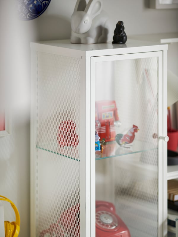 A metal/white BAGGEBO glass-door cabinet in the childrens room