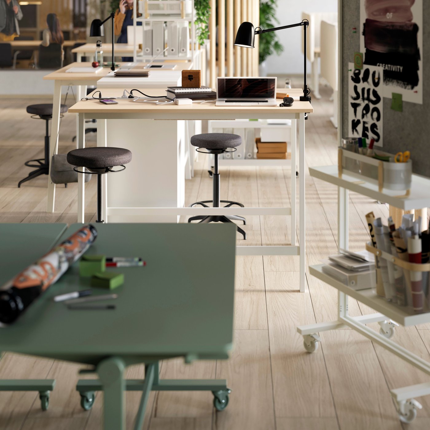 A white RISATORP desk organiser and MITTZON sit/stand desks in an office setting