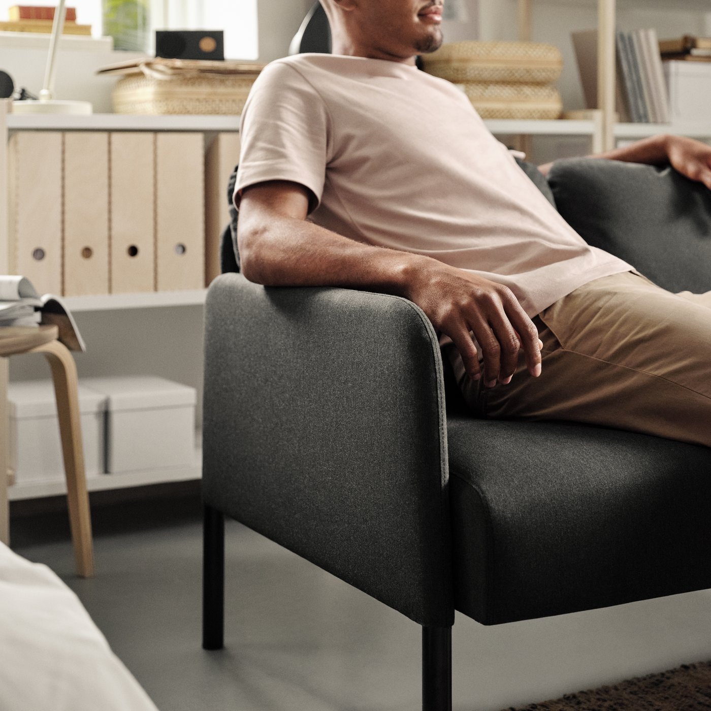 A Knisa dark grey GLOSTAD 2-seat sofa in the living room