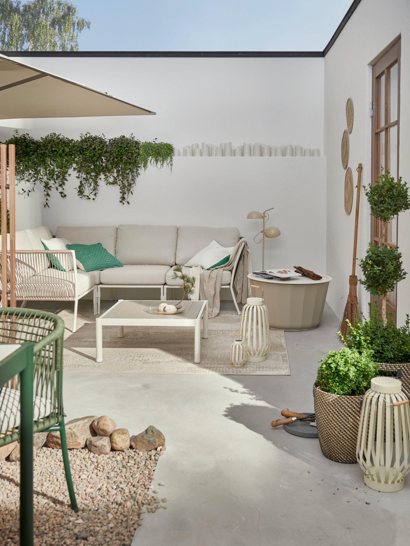 An in/outdoor dark grey/beige RÅGKORN plant pot outside