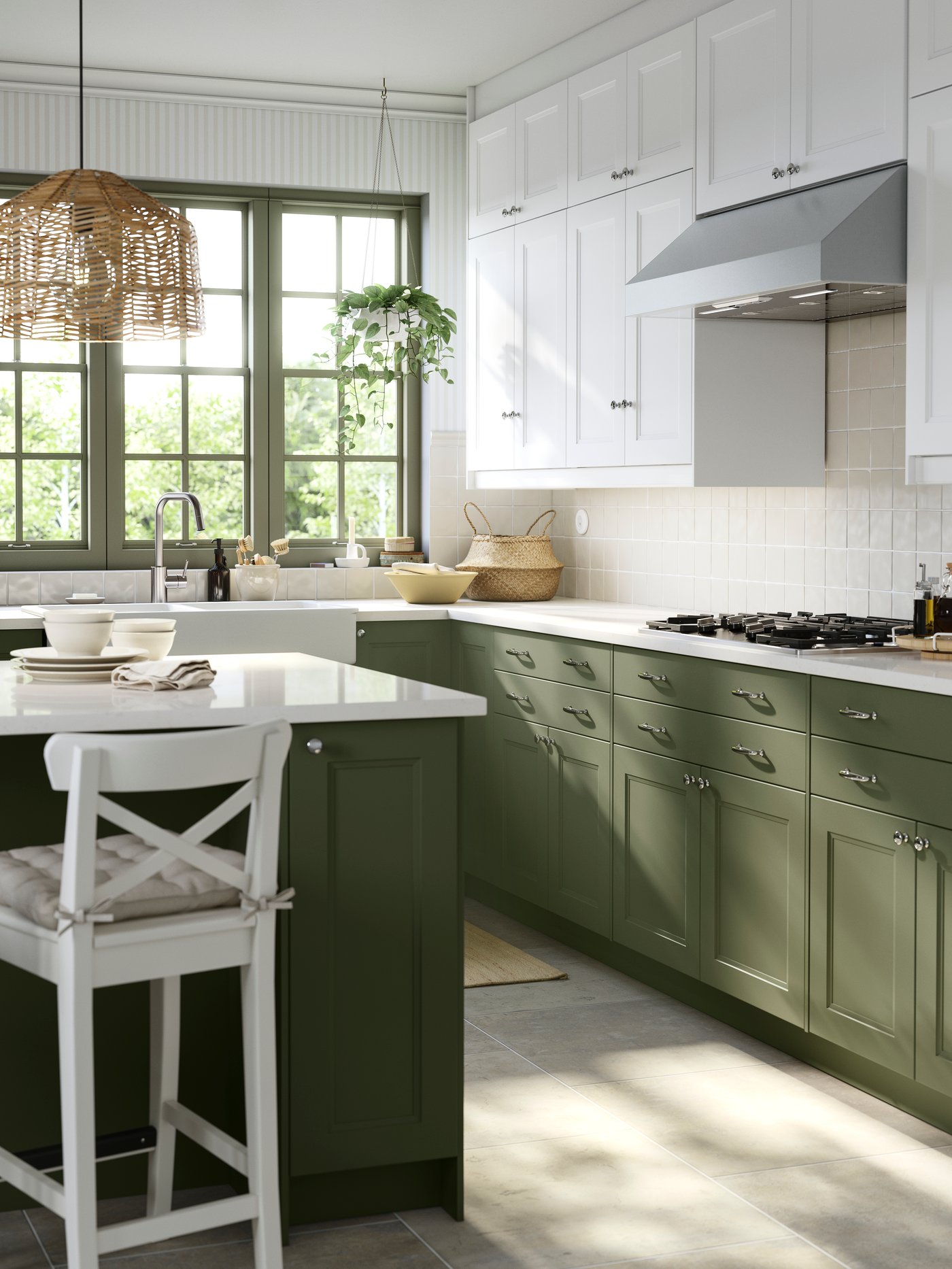 A kitchen with a large window has cabinets with gray-green and white AXSTAD fronts and a kitchen island with seating.