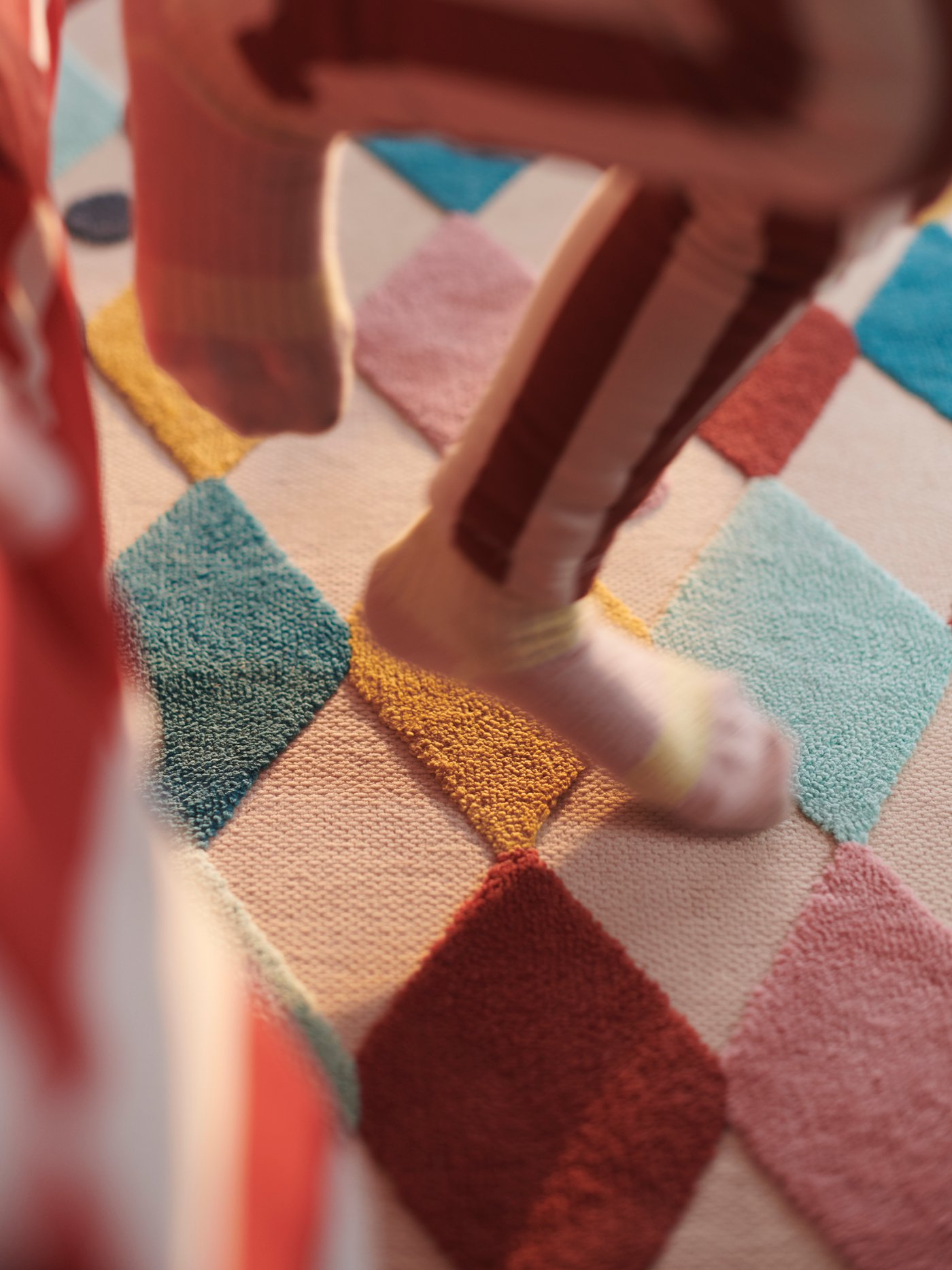 A harlequin pattern/multicolour BUSENKEL rug in the NA