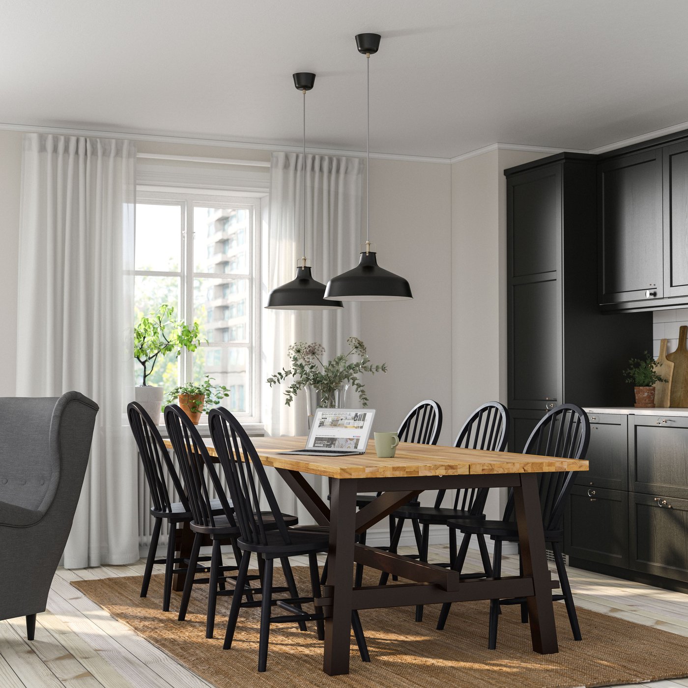 An acacia/black SKOGSTA dining table in the kitchen