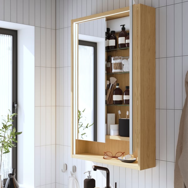 A FAXÄLVEN mirror cabinet in an oak finish with built-in lighting