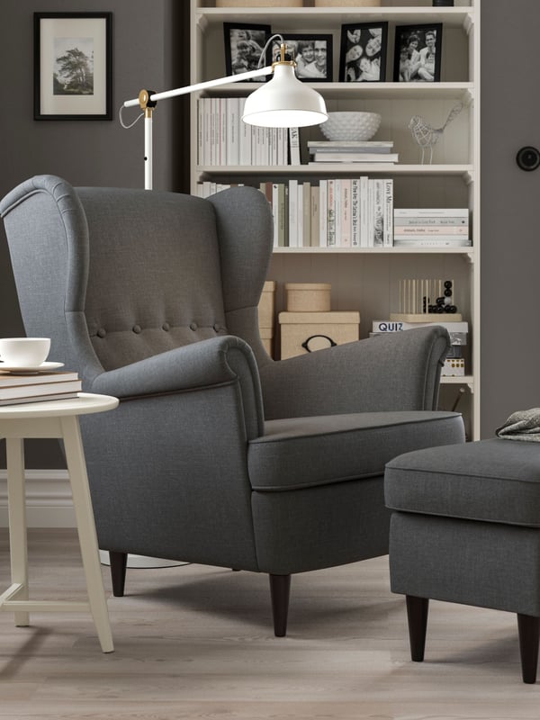 A Nordvalla dark grey STRANDMON footstool in the living room